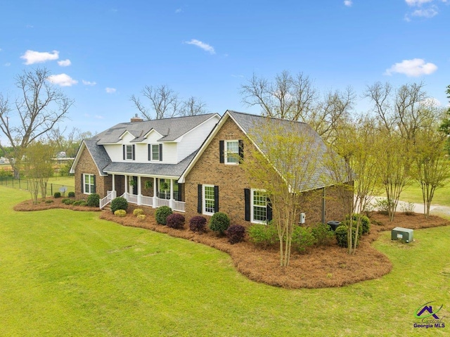 cape cod home featuring a front lawn and a porch