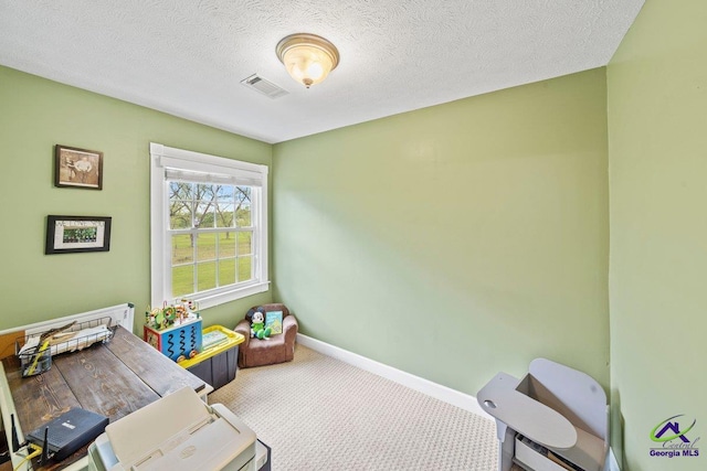 game room featuring carpet floors and a textured ceiling