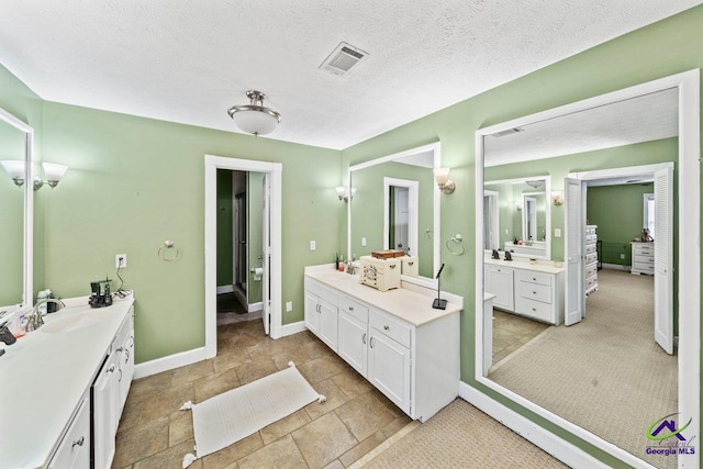 bathroom featuring vanity and a textured ceiling