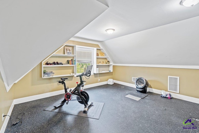 workout room with vaulted ceiling