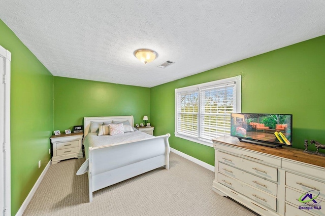 carpeted bedroom featuring a textured ceiling