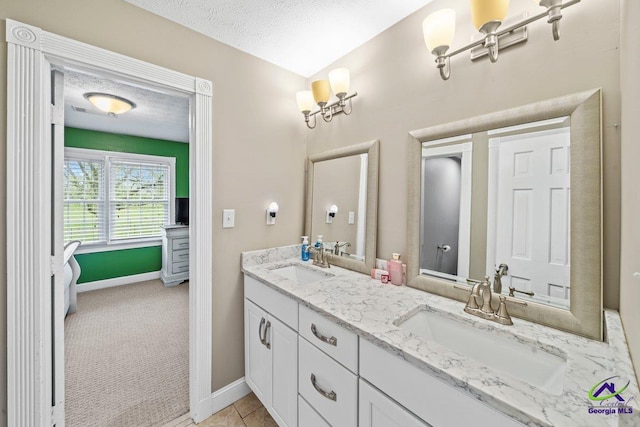 bathroom featuring vanity, tile patterned floors, and a textured ceiling