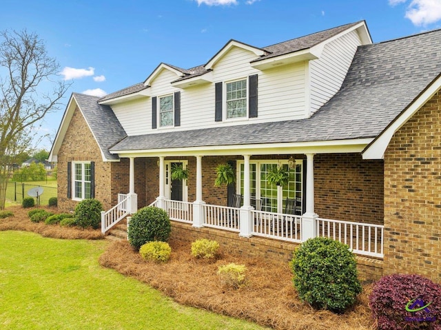 view of front of home with a porch and a front lawn