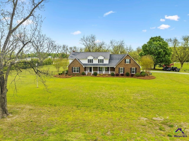 cape cod-style house with a porch and a front lawn