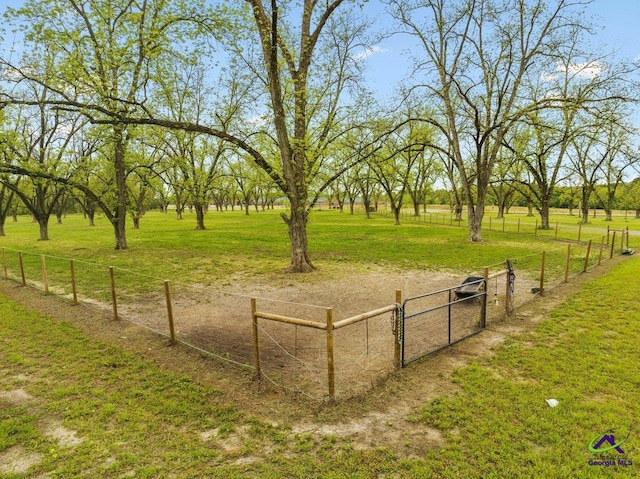 surrounding community with a rural view and a lawn