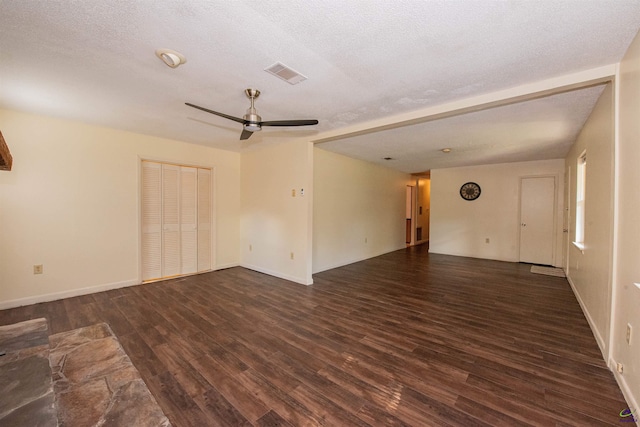 unfurnished room featuring a textured ceiling, dark wood-type flooring, and ceiling fan