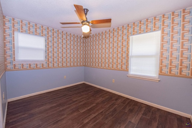 empty room featuring ceiling fan, wood-type flooring, and a textured ceiling