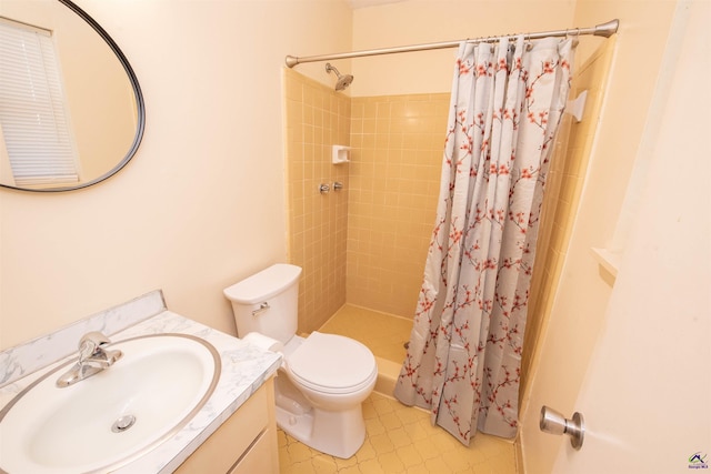 bathroom featuring vanity, curtained shower, and toilet