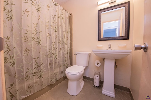 bathroom featuring walk in shower and toilet