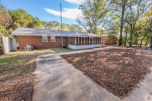 rear view of property with a sunroom