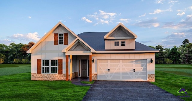687 Jasmine Dr, Macon, GA 31211 - view of front facade with driveway, brick siding, a front yard, and board and batten siding