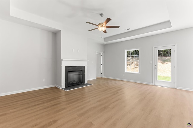 687 Jasmine Dr, Macon, GA 31211 - unfurnished living room with a ceiling fan, light wood-type flooring, a glass covered fireplace, and baseboards
