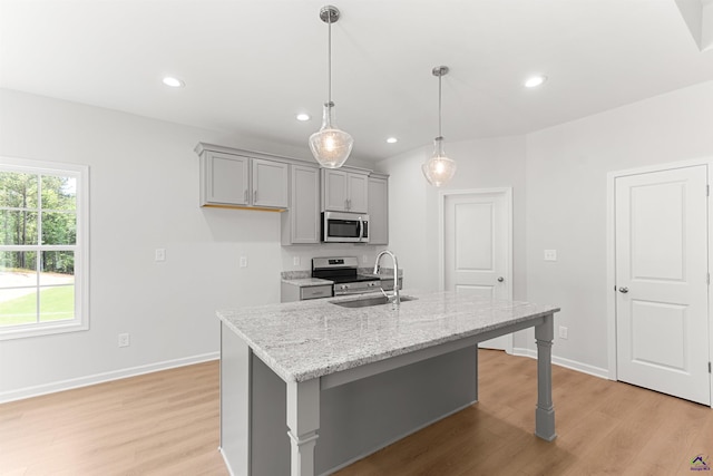 687 Jasmine Dr, Macon, GA 31211 - kitchen featuring stainless steel appliances, gray cabinetry, a sink, light wood-style floors, and an island with sink