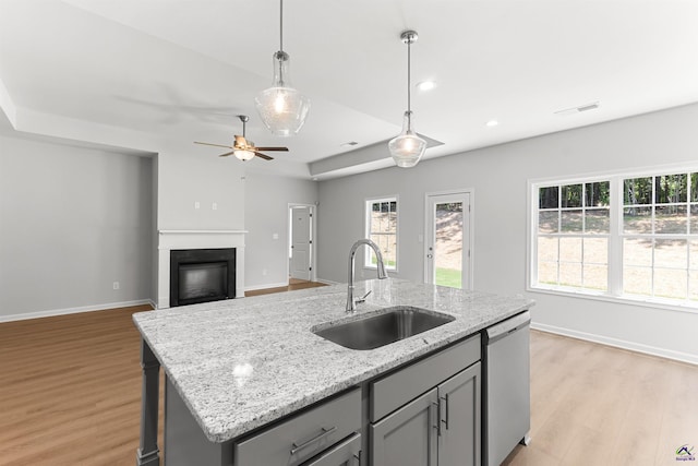 687 Jasmine Dr, Macon, GA 31211 - kitchen featuring a sink, stainless steel dishwasher, gray cabinetry, light wood-style flooring, and baseboards