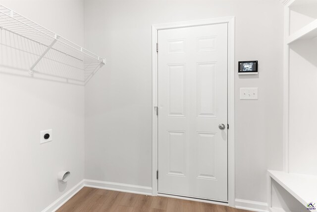 687 Jasmine Dr, Macon, GA 31211 - laundry room featuring electric dryer hookup, wood finished floors, and baseboards