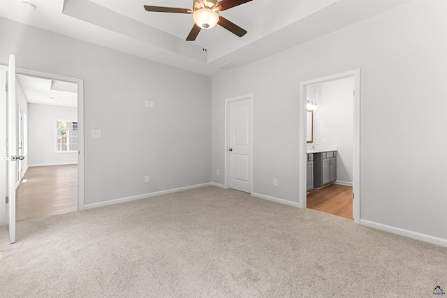 687 Jasmine Dr, Macon, GA 31211 - unfurnished bedroom with carpet, baseboards, ensuite bath, a ceiling fan, and a raised ceiling