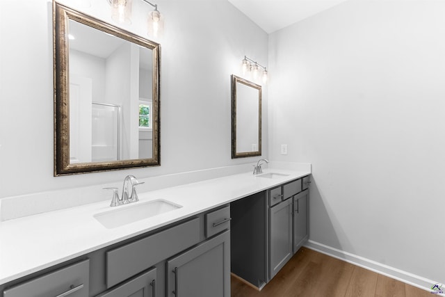 687 Jasmine Dr, Macon, GA 31211 - full bathroom with wood finished floors, double vanity, and baseboards