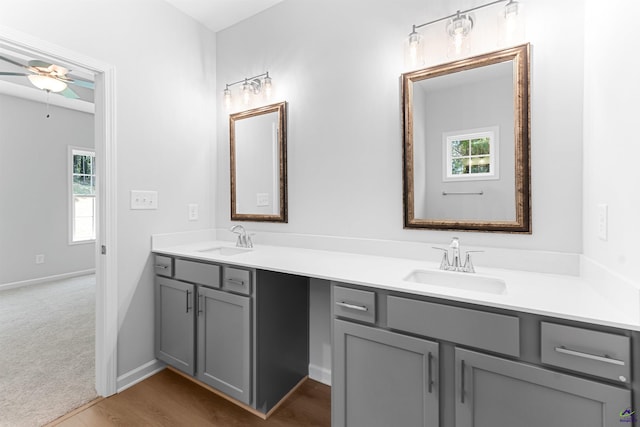 687 Jasmine Dr, Macon, GA 31211 - full bath featuring double vanity, ceiling fan, wood finished floors, and baseboards