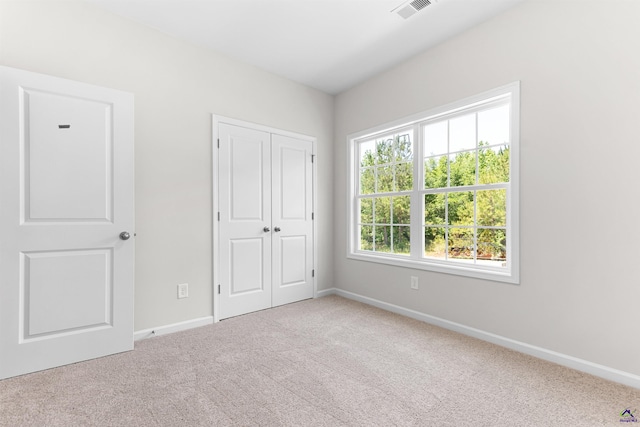 687 Jasmine Dr, Macon, GA 31211 - unfurnished bedroom with carpet, baseboards, and a closet