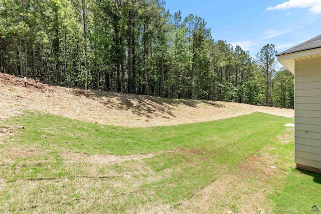 687 Jasmine Dr, Macon, GA 31211 - view of grassy yard featuring a forest view