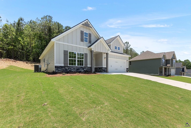 687 Jasmine Dr, Macon, GA 31211 - view of front of house with board and batten siding, concrete driveway, a garage, central AC, and a front lawn