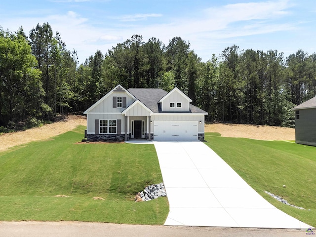 687 Jasmine Dr, Macon, GA 31211 - modern farmhouse with concrete driveway, board and batten siding, a front lawn, and stone siding