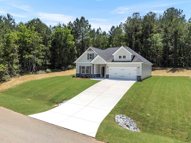 687 Jasmine Dr, Macon, GA 31211 - modern inspired farmhouse featuring driveway, a front lawn, board and batten siding, stone siding, and an attached garage