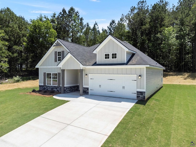 687 Jasmine Dr, Macon, GA 31211 - modern farmhouse style home featuring board and batten siding, driveway, a front yard, and stone siding