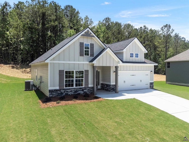 687 Jasmine Dr, Macon, GA 31211 - view of front of house with concrete driveway, board and batten siding, a front yard, and central air condition unit