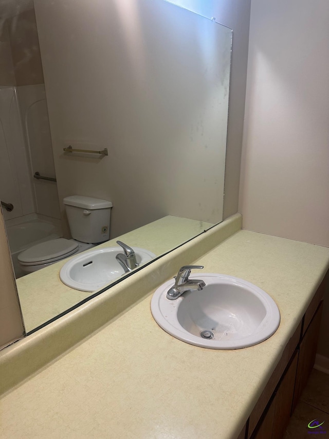 full bathroom with vanity,  shower combination, and toilet