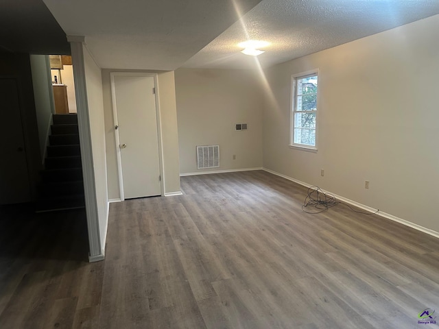 interior space featuring wood-type flooring and a textured ceiling