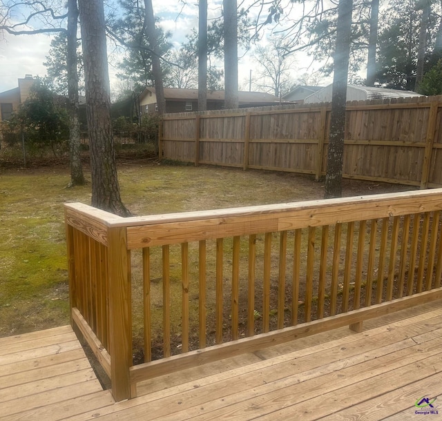 wooden terrace with a lawn