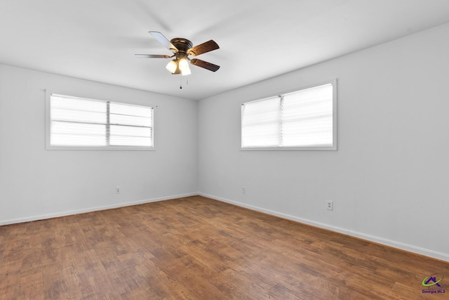 unfurnished room featuring hardwood / wood-style flooring, a healthy amount of sunlight, and ceiling fan