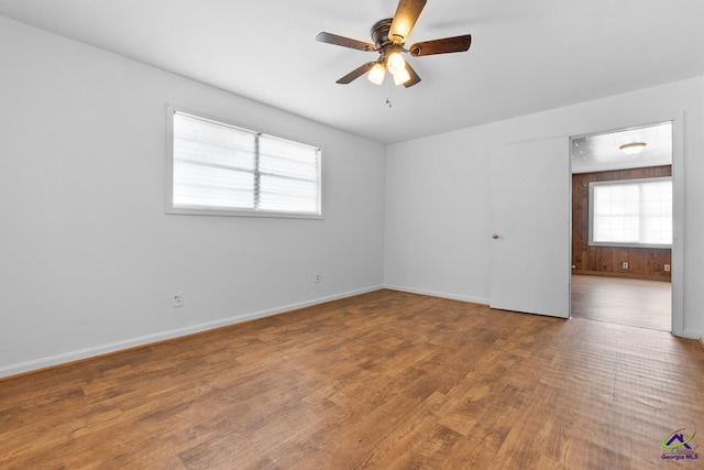 spare room with hardwood / wood-style floors and ceiling fan