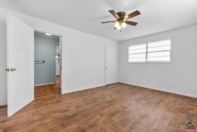 interior space featuring dark wood-type flooring and ceiling fan