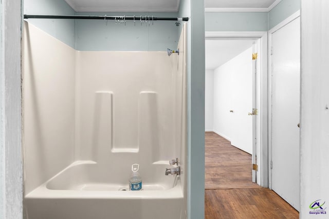 bathroom featuring hardwood / wood-style flooring and shower / tub combination