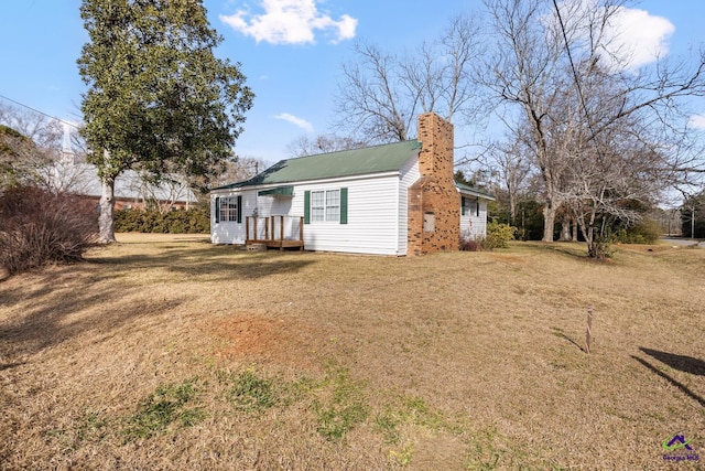 back of property featuring a lawn