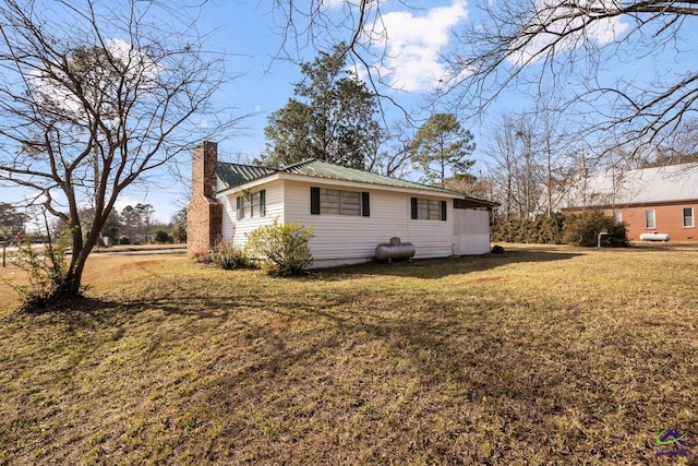 back of house with a lawn