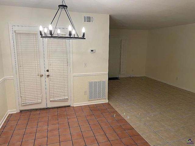 unfurnished dining area featuring tile patterned flooring and an inviting chandelier