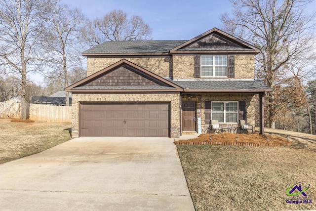 craftsman-style house with a garage, covered porch, and a front lawn