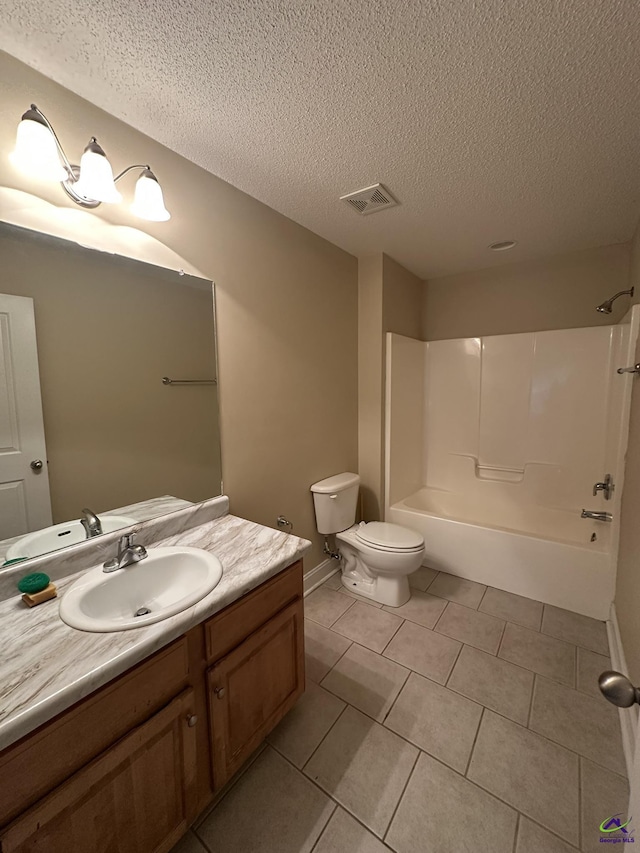 full bathroom with washtub / shower combination, vanity, toilet, tile patterned floors, and a textured ceiling