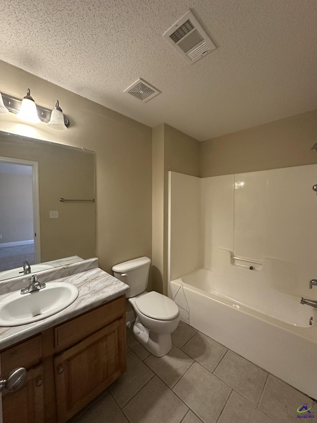 full bathroom with shower / washtub combination, tile patterned flooring, vanity, toilet, and a textured ceiling