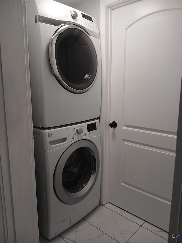 laundry room with stacked washer / dryer