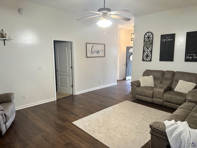 living room featuring dark wood-type flooring and ceiling fan