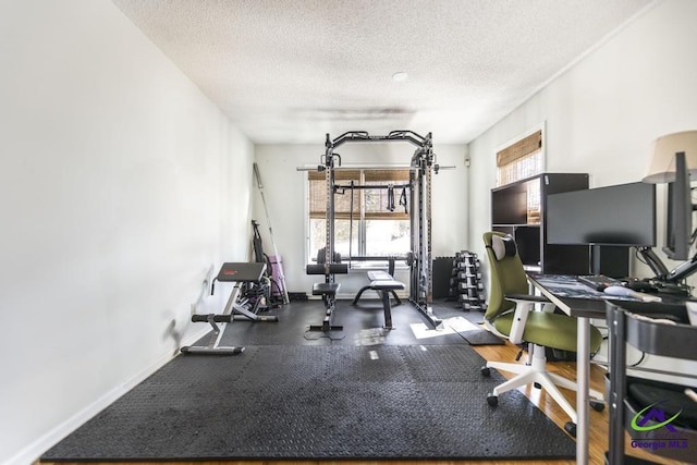 exercise room with a textured ceiling