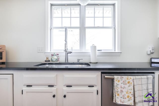 interior space featuring white cabinetry, sink, a wealth of natural light, and stainless steel dishwasher