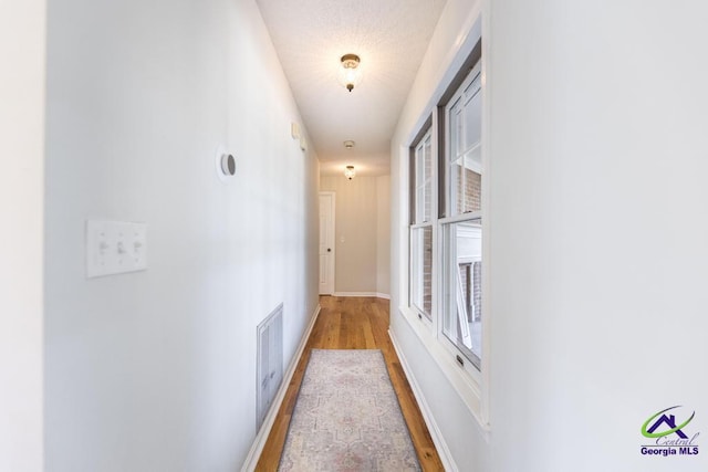 hall with light hardwood / wood-style floors