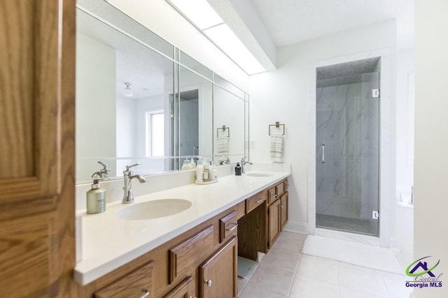 bathroom featuring vanity, an enclosed shower, and tile patterned flooring