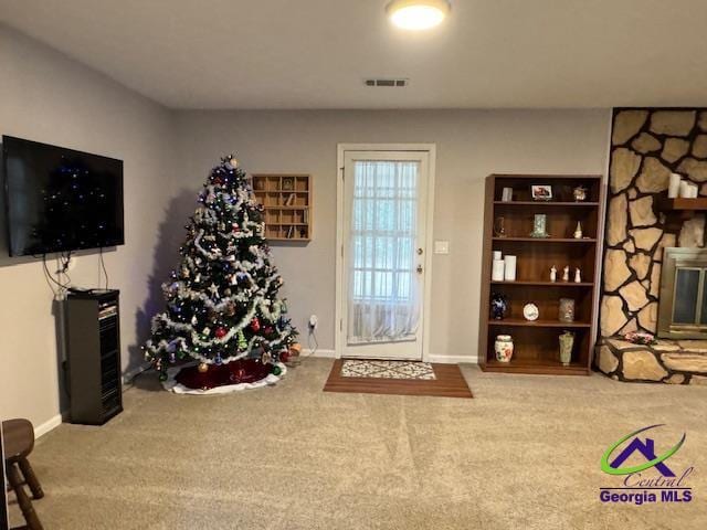 interior space featuring a fireplace and carpet