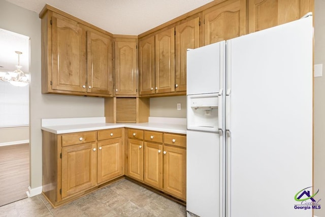 kitchen with white refrigerator with ice dispenser